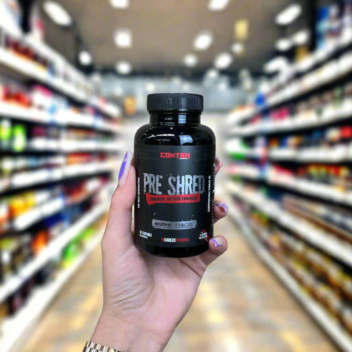 Close-up of (Conteh Pre Shred 90 Capsules) held up inside My Supplement Shop, clearly showing the front label in a Sports Nutrition setting.